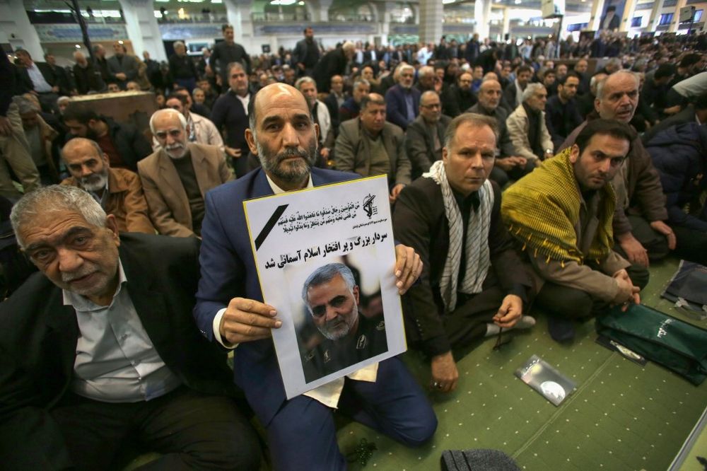 An Iranian man holds a poster of slain Iranian Revolutionary Guards Major General Qasem Soleimani, who was killed in a US air strike in Baghdad, during a mourning prayer in Iran's capital Tehran on January 3, 2020. u00e2u20acu201d AFP pic