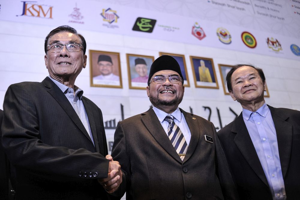 Minister in the Prime Minister's Department Datuk Seri Mujahid Yusof Rawa shakes hands with Jiao Zong president Datuk Ong Chiow Chuen (left) after meeting Dong Zong representatives in Putrajaya January 15, 2020. u00e2u20acu201d Picture by Shafwan Zaidon