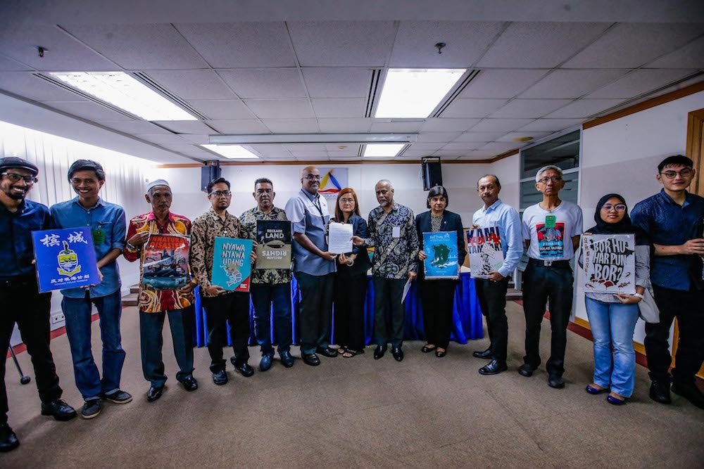 Penang Forum committee member, Khoo Salma Nasution, gives a copy of the Penang Tolak Tambak memorandum to Suhakam commissioner Jerald Joseph in Kuala Lumpur January 16, 2020. u00e2u20acu201d Picture by Hari Anggara