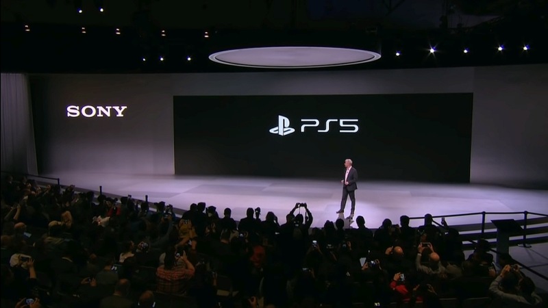 A YouTube screenshot of Sony Interactive Entertainment President and CEO Jim Ryan presenting the PS5 logo at CES 2020.