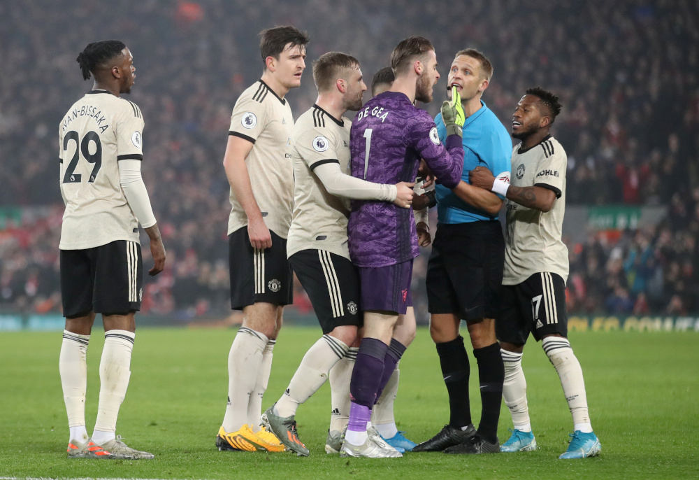 Manchester Unitedu00e2u20acu2122s David de Gea is held back by Luke Shaw as he remonstrates with referee Craig Pawson, who is held by Fred during their Premier League match against Liverpool January 19, 2020. u00e2u20acu201d Picture by Action Images via Reuters/Carl Recine 