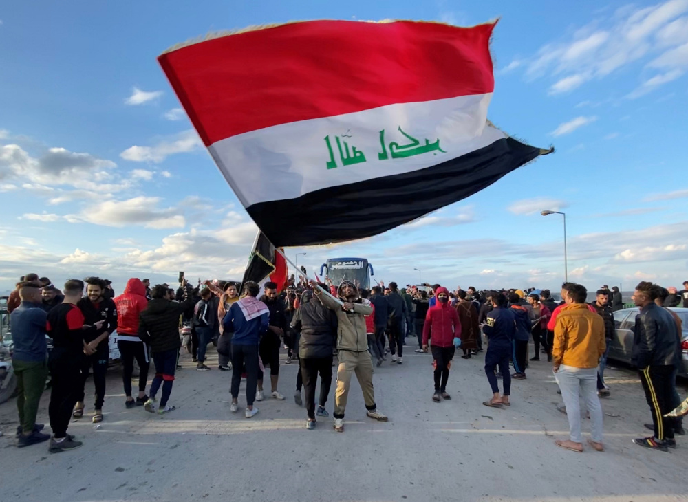 A demonstrator carries an Iraqi flag during ongoing anti-government protests in Nassiriya January 22, 2020. u00e2u20acu201d Reuters pic