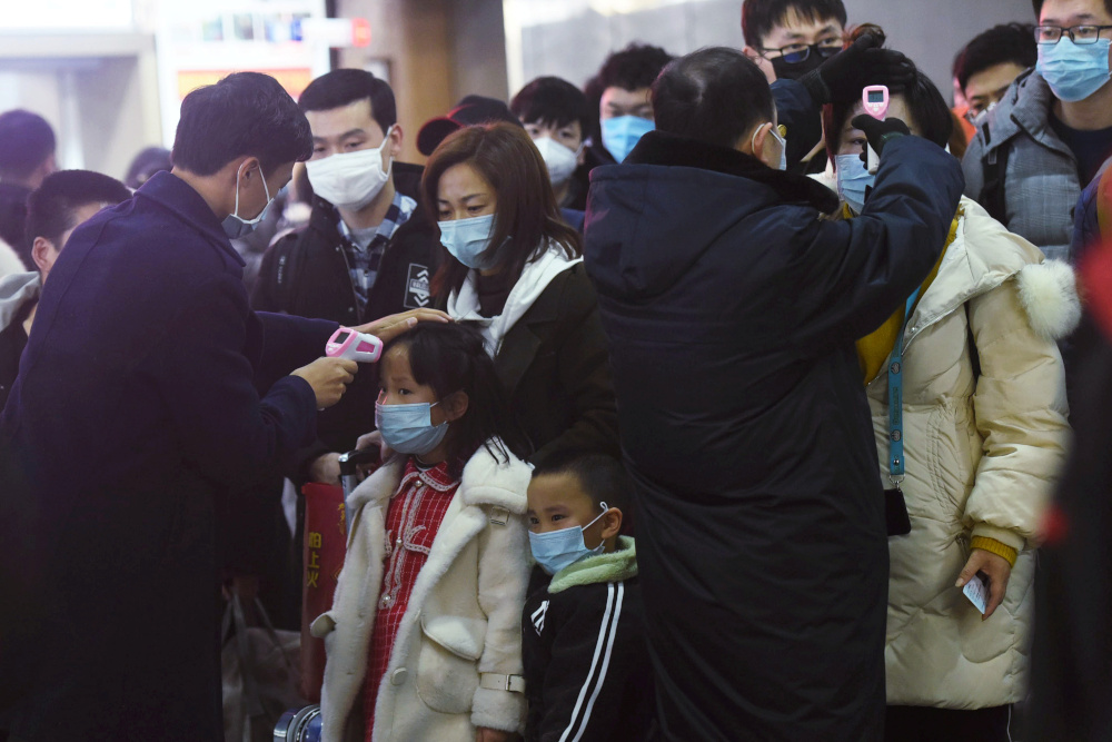 Staff members check body temperatures of the passengers arriving from the train from Wuhan to Hangzhou, at Hangzhou Railway Station ahead of the Chinese Lunar New Year January 23, 2020. u00e2u20acu201d Picture by China Daily via Reuters