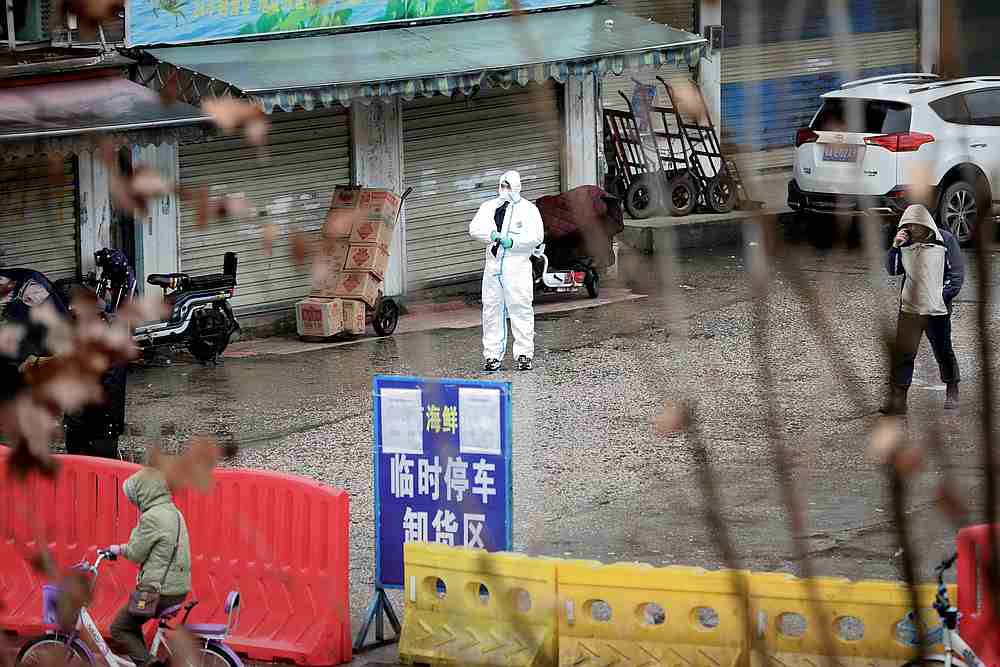 A worker in a protective suit is seen at the closed seafood market in Wuhan, Hubei province, China January 10, 2020. u00e2u20acu201d Reuters pic 