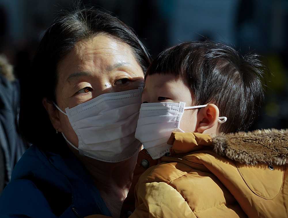 A mother and her child wear a mask to prevent contacting a new coronavirus in Seoul, South Korea January 26, 2020. u00e2u20acu201d Yonhap pic via Reuters