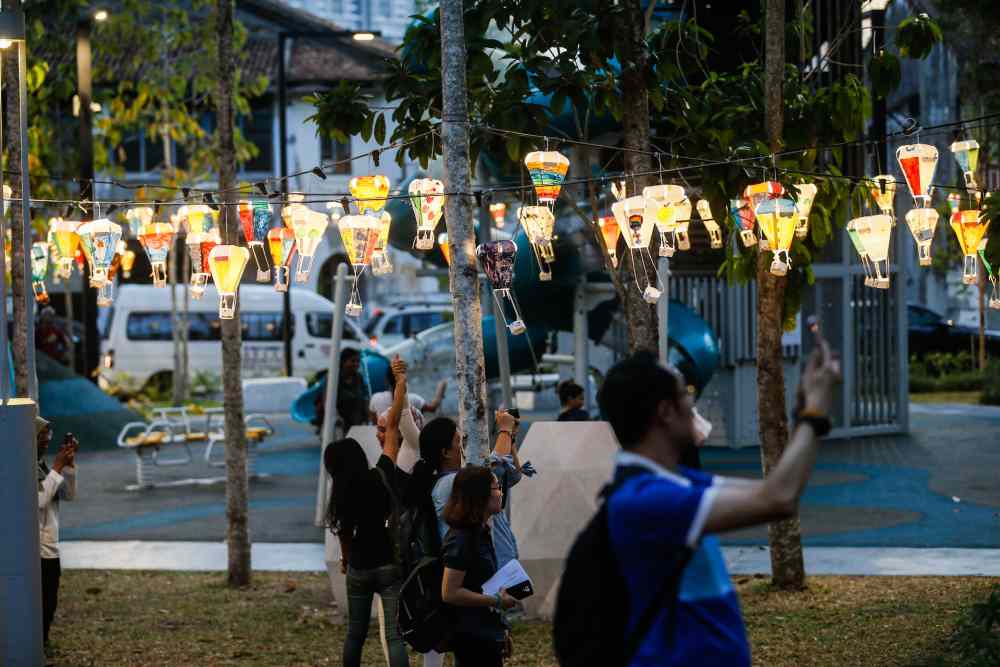 Visitors take photos of the mini hot air balloon decorations at Sia Boey in George Town January 10, 2020.