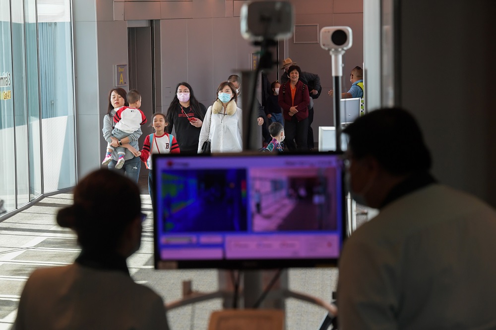 Health officers screen arriving passengers from China with thermal scanners at Changi International airport in Singapore on January 22, 2020 as authorities increased measure against coronavirus. u00e2u20acu201d AFP pic
