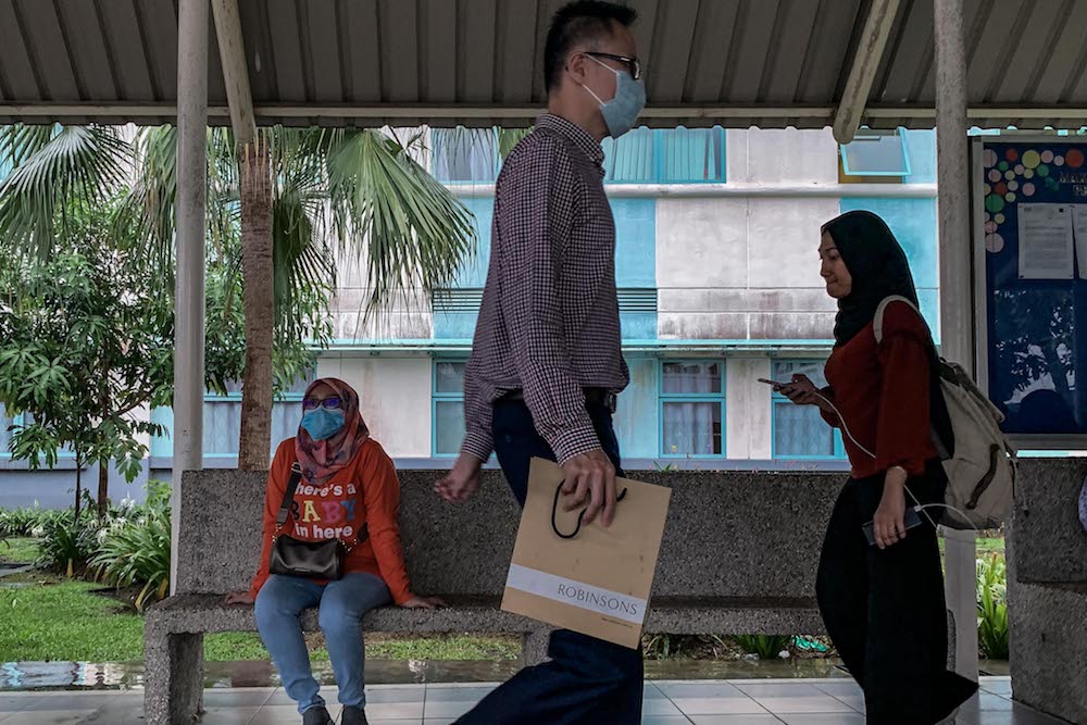 People wearing face masks are seen outside Sungai Buloh Hospital January 29, 2020. — Picture by Hari Anggara