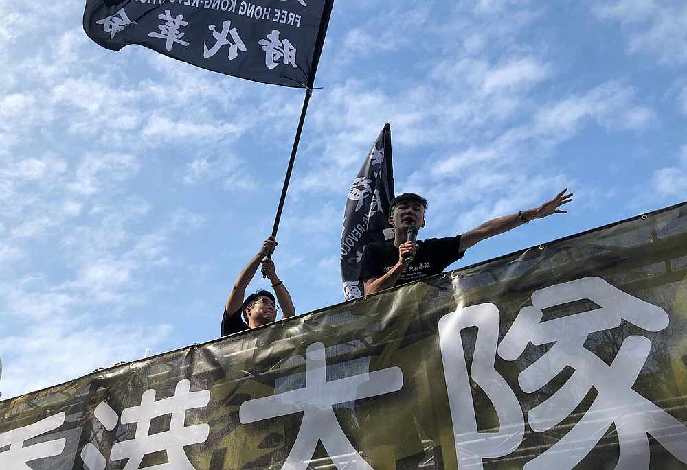 A protester addresses the crowd as another one waves a flag in support of Hong Kong's protests, during a rally against Kuomintang's presidential candidate Han Kuo-yu, in Kaohsiung, Taiwan December 21, 2019. u00e2u20acu201d Reuters pic