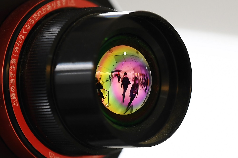 Passengers who arrived on one of the last flights from Wuhan are reflected in the lens of an advanced thermo camera as they walk through a health screening station at Narita airport in Chiba prefecture, outside Tokyo January 23, 2020. u00e2u20acu201d AFP pic