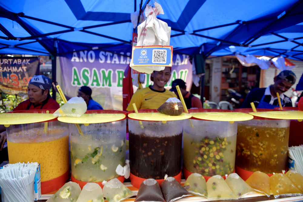 The QR code for the Touch u00e2u20acu02dcN Go e-wallet is displayed at a beverage stall at the Kampung Baru Ramadan Bazaar in Kuala Lumpur May 14, 2019. u00e2u20acu201d Bernama pic