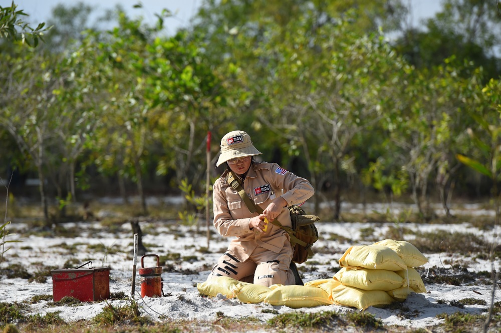 This picture taken on January 6, 2020 shows a member of an all-female demining team preparing to detonate unexploded ordnance at a landmine site in the Trieu Phong district in Quang Tri province, Vietnam. u00e2u20acu201d AFP pic