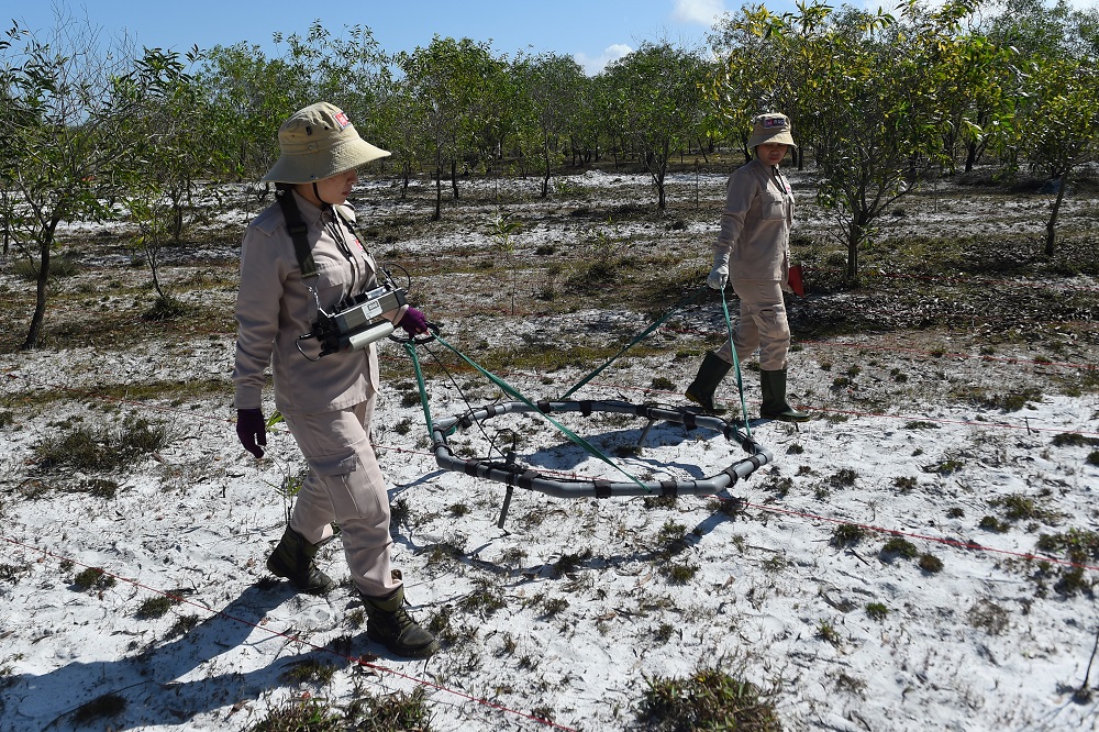 This picture taken on January 6, 2020 shows members of an all-female demining team exploring for unexploded ordnance at a landmine site in the Trieu Phong district in Quang Tri province, Vietnam. — AFP pic