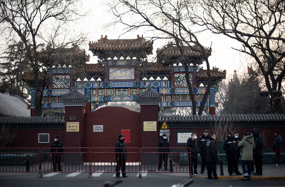 Policemen wearing protective facemasks to help stop the spread of a deadly SARS-like virus which originated in the central city of Wuhan, are seen in front of the closed gate of the Lama Temple in Beijing January 25, 2020. u00e2u20acu201d AFP pic
