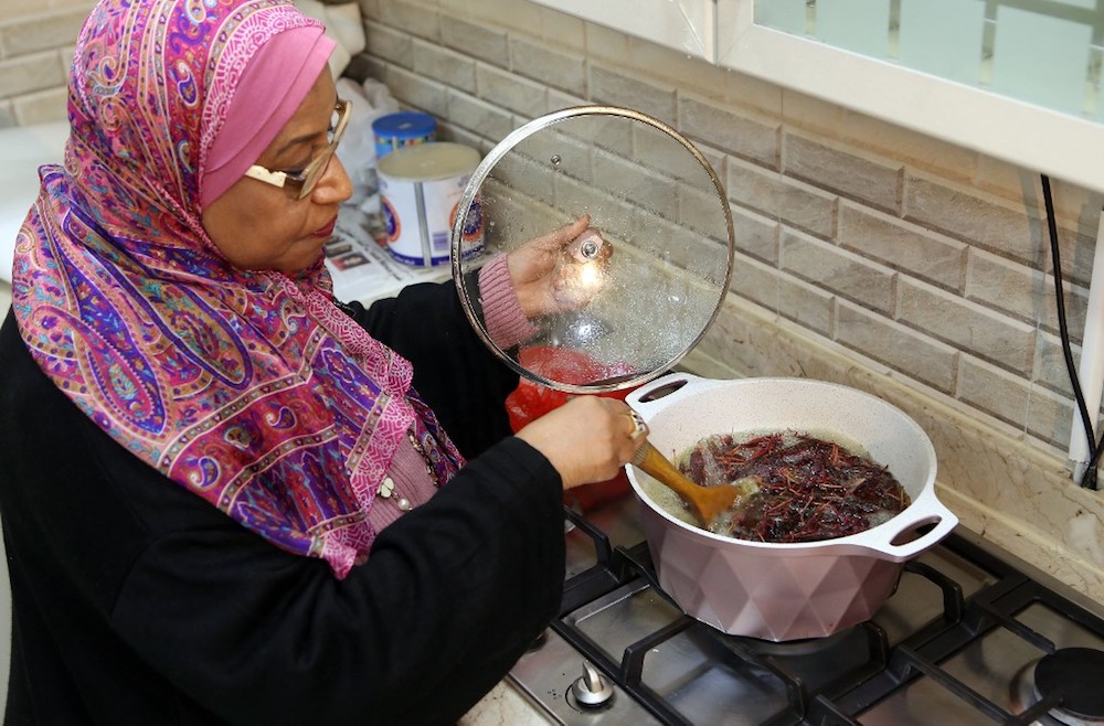 Moudi al-Miftah, a 64-year-old journalist, cooks locust at her home in Al-Ahmadi, some 35 kilometres south of Kuwait City, January 25, 2020. u00e2u20acu201d AFP pic