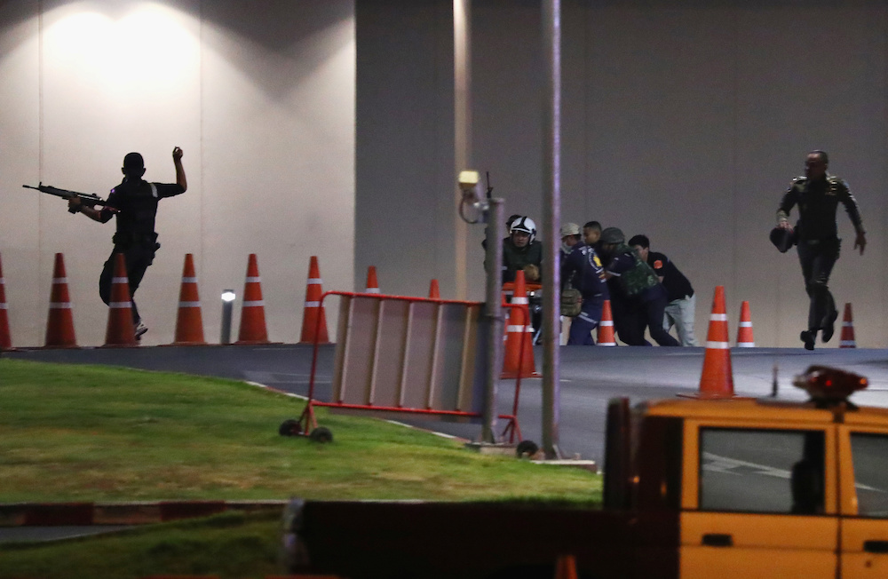 Thai security forces take cover during a gun battle at the Terminal 21 shopping mall to try to stop a soldier on a rampage after a mass shooting, Nakhon Ratchasima February 9, 2020. u00e2u20acu201d Reuters pic