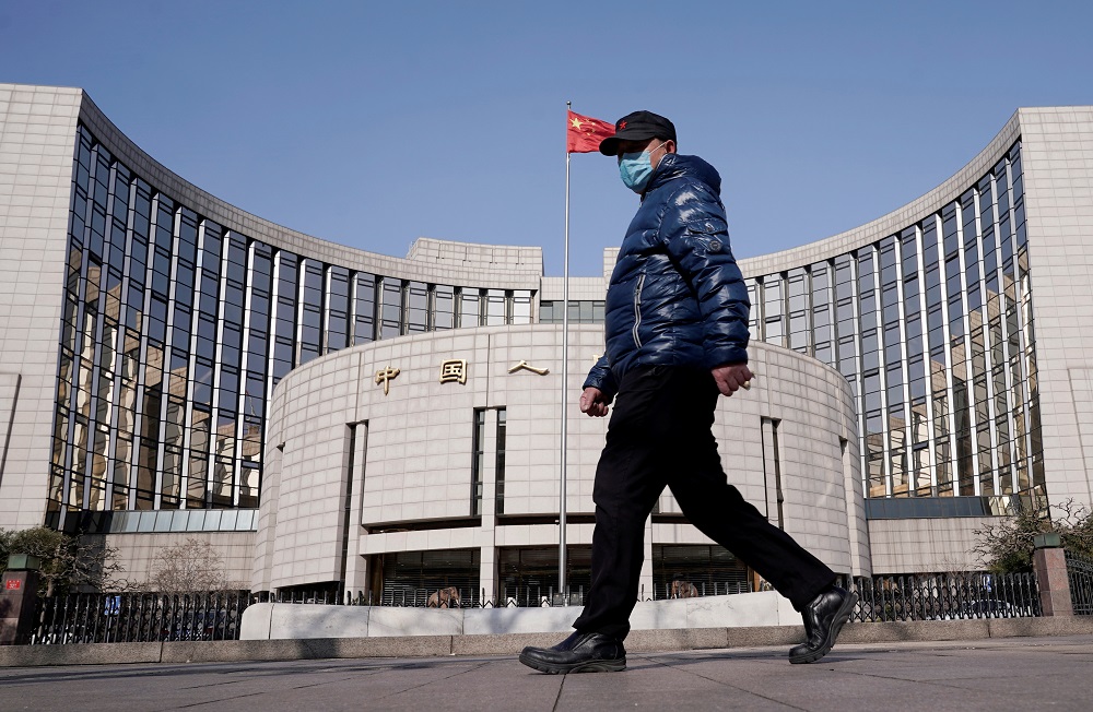 A man wearing a mask walks past the headquarters of the People's Bank of China, the central bank, in Beijing as the country is hit by an outbreak of the new coronavirus, February 3, 2020. u00e2u20acu201d Reuters pic