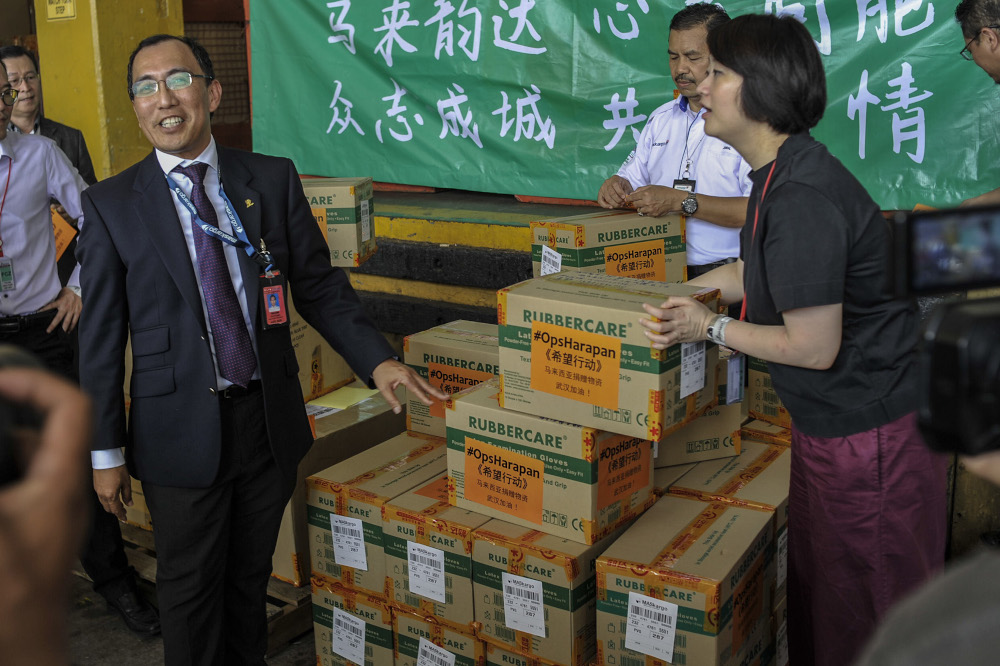 (From left) MASKargo CEO Ibrahim Mohamed Salleh and Ops Harapan founder Ng Yeen Seen inspect cartons consisting of N95 masks, surgical masks and gloves meant for the first humanitarian shipment to China in Sepang, February 4, 2020. u00e2u20acu201d Picture by Shafwan 
