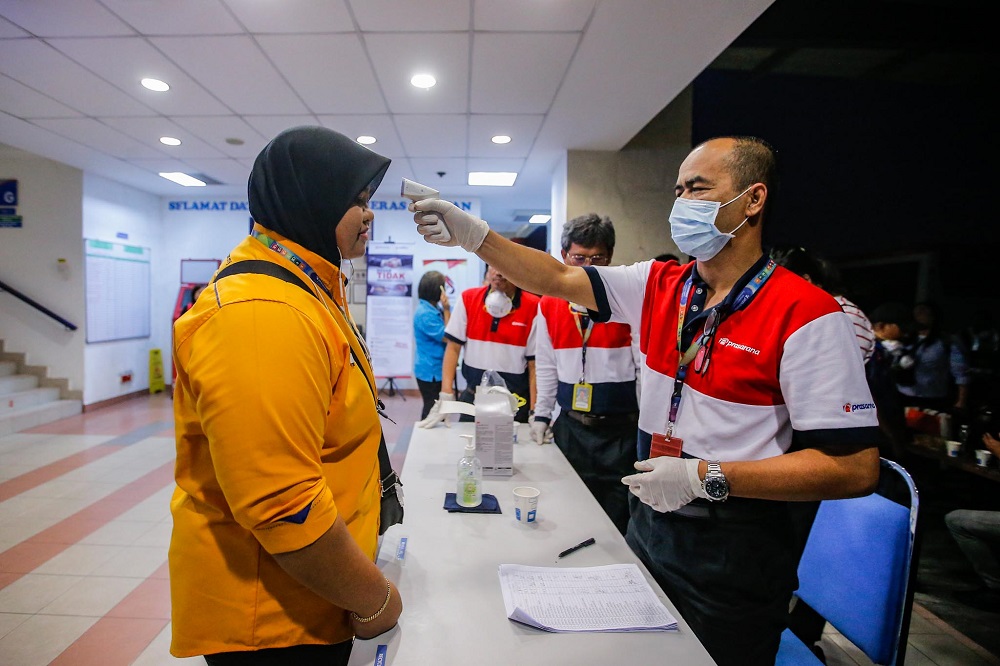 A staff gets her temperature checked at the Rapid KL depot in Kuala Lumpur February 7, 2020.