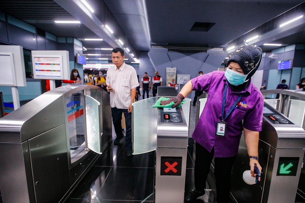 A worker is seen cleaning the automatic fare collection gates at the Bandar Tun Hussein Onn MRT station in Kuala Lumpur February 7, 2020. 