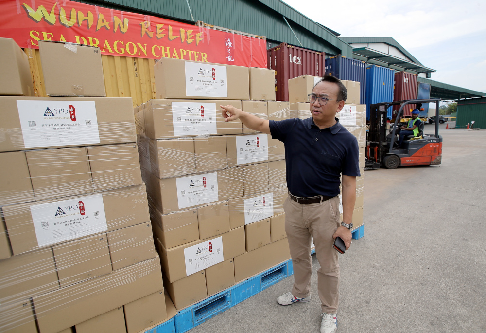 The Young President Organisation’s (YPO) Sea Dragon regional chapter assistant forum officer Lai Voon Wai showing three million medical grade gloves for hospital workers in Wuhan, China. — Picture by Farhan Najib