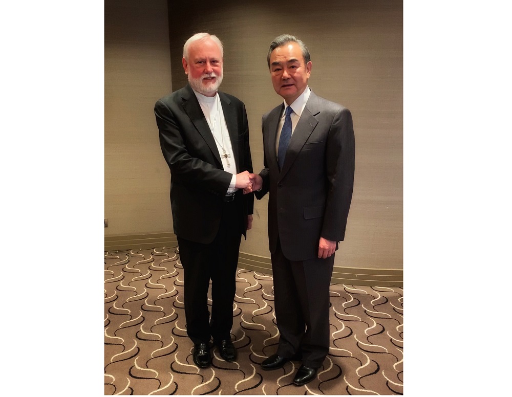 Handout photograph shows Archbishop Paul Gallagher (left) shaking hands with Chinese Foreign Minister Wang Yi on the sidelines of the Munich 2020 security conference in Munich February 14, 2020. u00e2u20acu201d Handover by Vatican Media via AFP