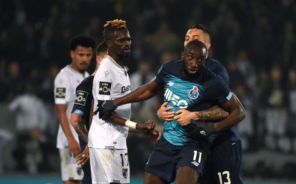 FC Portou00e2u20acu2122s Moussa Marega (centre) reacts and attempts to leave the pitch after hearing racists chants as teammate Alex Telles tries to stop him during the match against Vitoria Guimaraes SC at the Dom Alfonso Henriques stadium in Guimaraes February 16, 