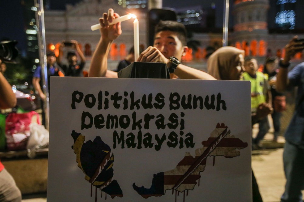 A protester lights a candle during a rally at Dataran Merdeka in Kuala Lumpur February 25, 2020. — Picture by Hari Anggara