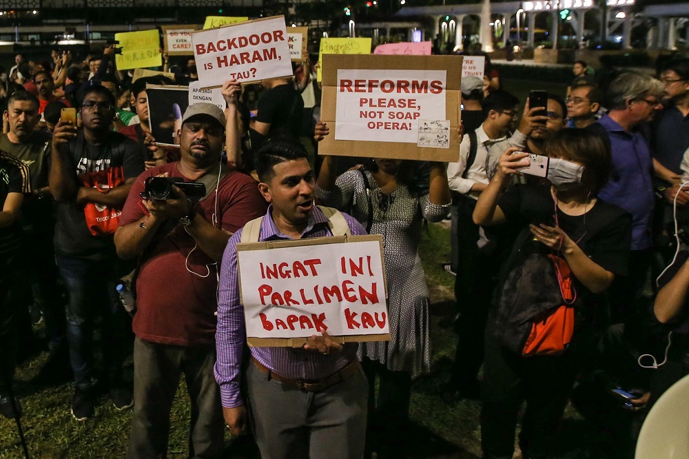 Protesters hold up posters during a rally at Dataran Merdeka in Kuala Lumpur February 25, 2020. u00e2u20acu201d Picture by Hari Anggara