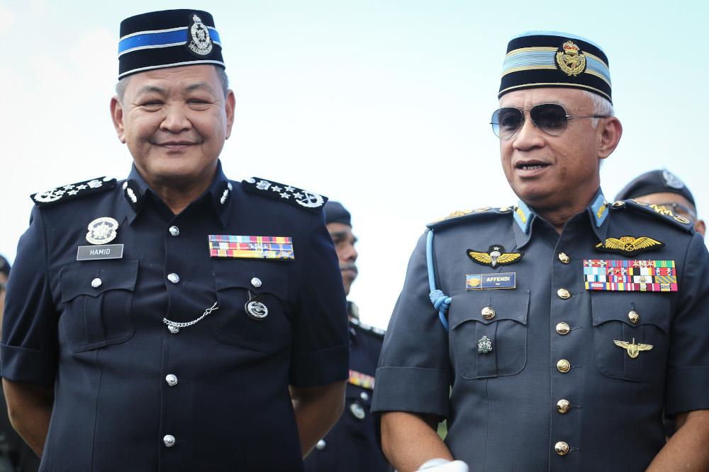 IGP Tan Sri Abdul Hamid Bador and Chief of Defence Force Gen Tan Sri Affendi Buang speak to reporters outside Istana Negara in Kuala Lumpur February 28, 2020. — Picture by Yusof Mat Isa