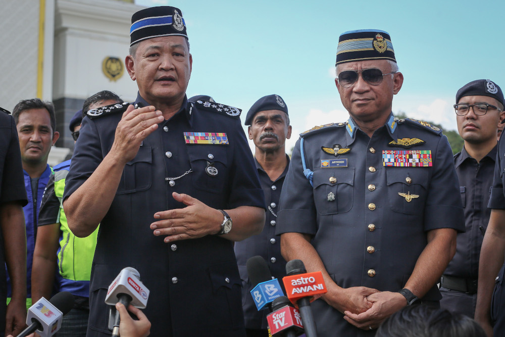 IGP Tan Sri Abdul Hamid Bador and Chief of Defence Force Gen Tan Sri Affendi Buang speak to reporters outside Istana Negara in Kuala Lumpur February 28, 2020. u00e2u20acu201d Picture by Yusof Mat Isa
