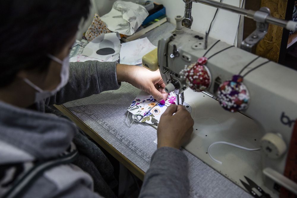 Tailor Elase Wong making masks out of patterned material at a shop in Hong Kong. u00e2u20acu201d AFP pic