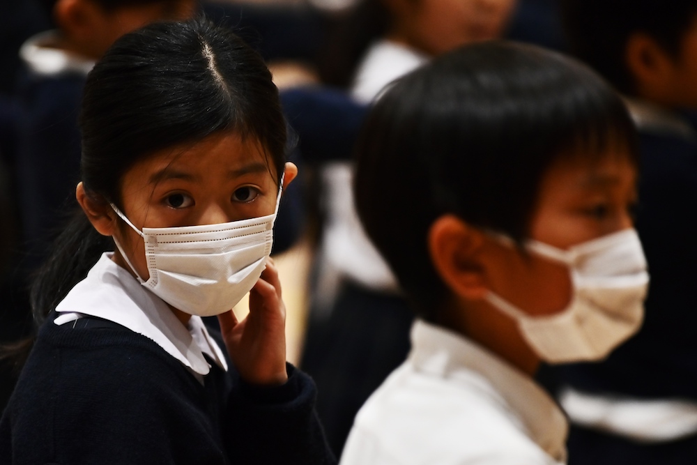 Pupils of the Ariake-nishi Gakuen elementary school wear face masks during an event marking six months till the Tokyo 2020 Paralympic Games in Tokyo February 25, 2020. u00e2u20acu201d AFP pic