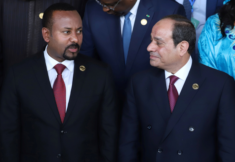Egyptian President Abdel Fattah el-Sisi talks with Ethiopian Prime Minister Abiy Ahmed at the opening of the 33rd Ordinary Session of the Assembly of the Heads of State and the Government of the African Union (AU) in Addis Ababa, Ethiopia, February 9, 202