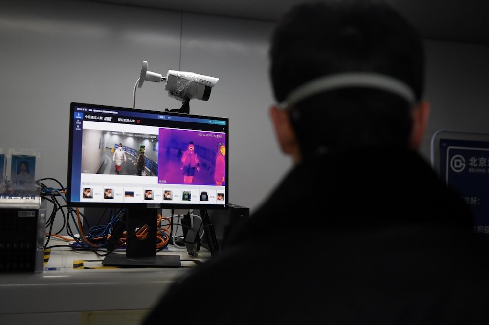 A security guard keeps watch as an AI-powered system developed by Chinese tech firm Megvii screens commuters for fevers as they enter a metro station in Beijing, February 6, 2020. u00e2u20acu201d AFP pic