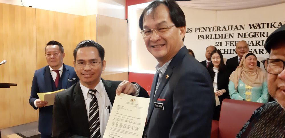 State Pakatan Harapan coordinator for Hulu Rajang parliamentary constituency Abun Sui Anyit (left) receiving his letter of appointment from state PKR chief Baru Bian February 21, 2020. u00e2u20acu201d Picture by Sulok Tawie