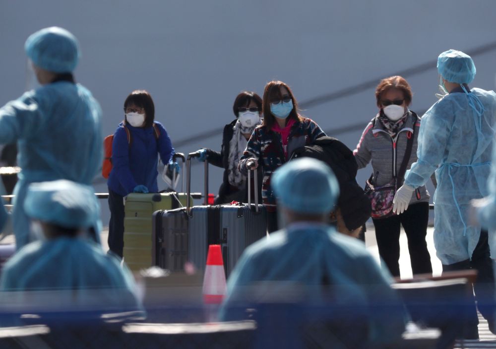 Passengers wearing masks leave the coronavirus-hit cruise ship Diamond Princess at Daikoku Pier Cruise Terminal in Yokohama, south of Tokyo February 21, 2020. u00e2u20acu2022 Reuters pic