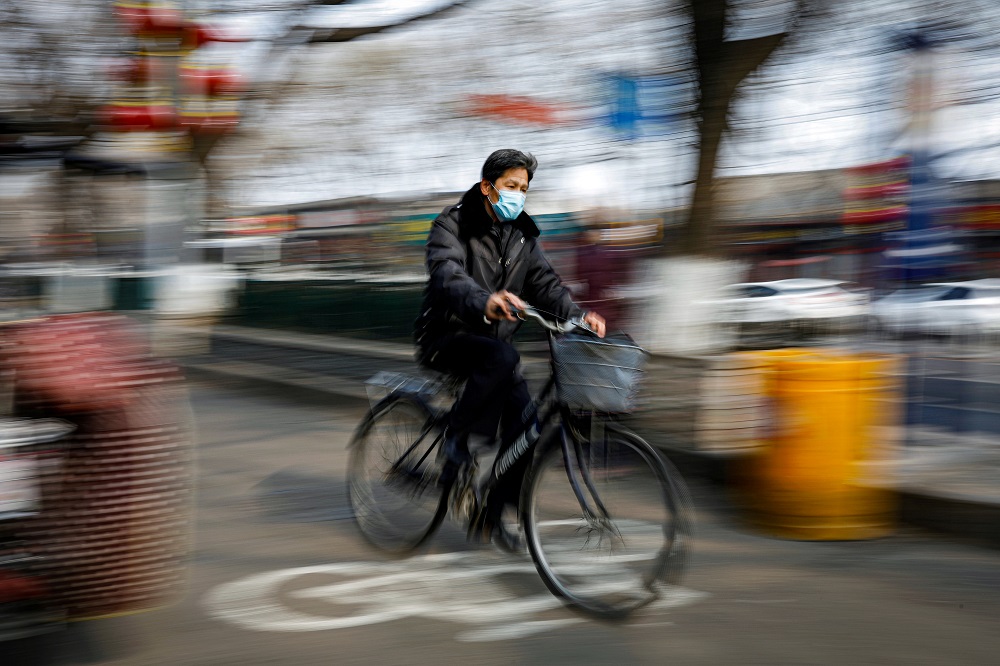 A man wearing a face mask rides a bicycle, as the country is hit by an outbreak of the novel coronavirus, in Beijing February 12, 2020. u00e2u20acu201d Reuters pic