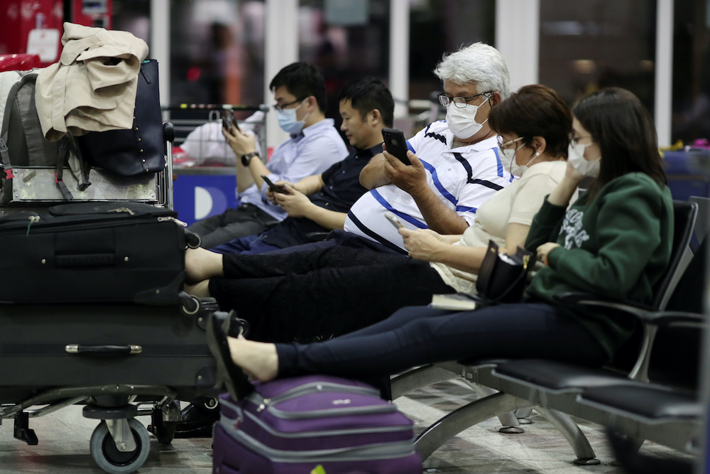 Travellers, wearing masks as a precautionary measure to avoid contracting coronavirus, are seen at Guarulhos International Airport in Guarulhos, Sao Paulo state, Brazil, January 31, 2020. u00e2u20acu201d Reuters pic
