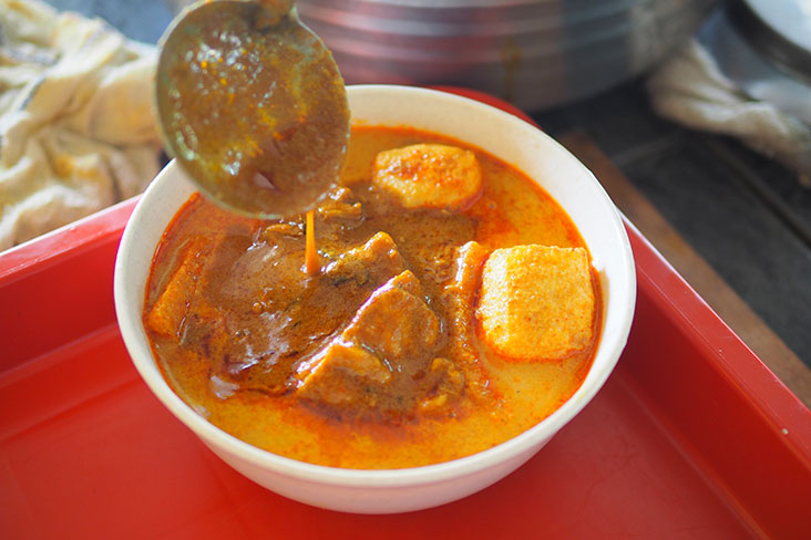 The recipe includes a thicker curry with tender chicken pieces and potatoes that is ladled on before serving