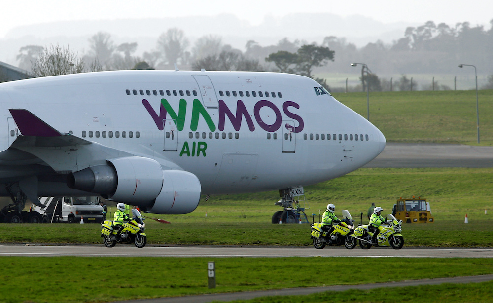 Police officers ride next to a recently landed plane carrying passengers who have been under quarantine on the Diamond Princess, at RAF Boscombe Down in Amesbury, Britain, February 22, 2020. u00e2u20acu201d AFP picnn