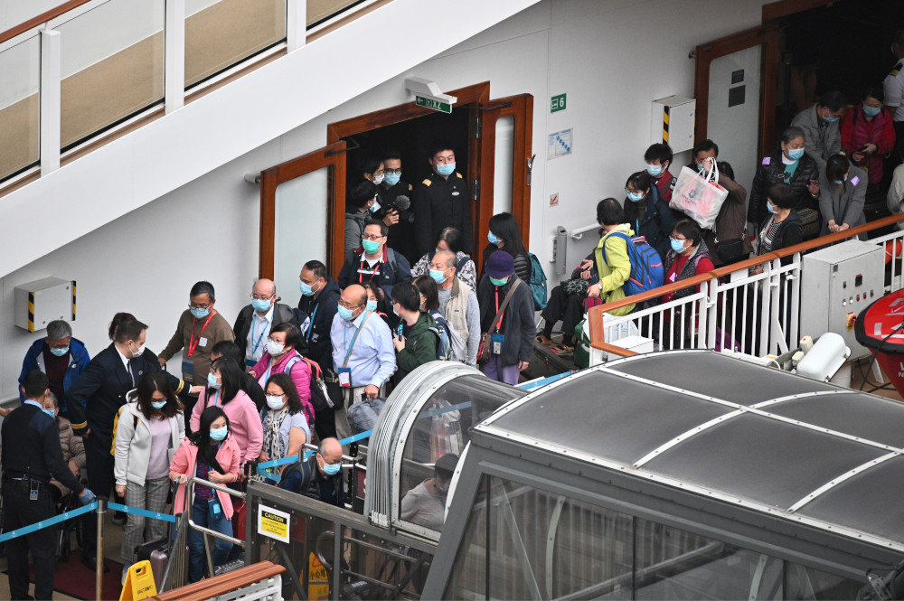 Passengers queue up to finally disembark from the World Dream cruise ship at the Kai Tak cruise terminal in Hong Kong February 9, 2020. u00e2u20acu201d AFP pic