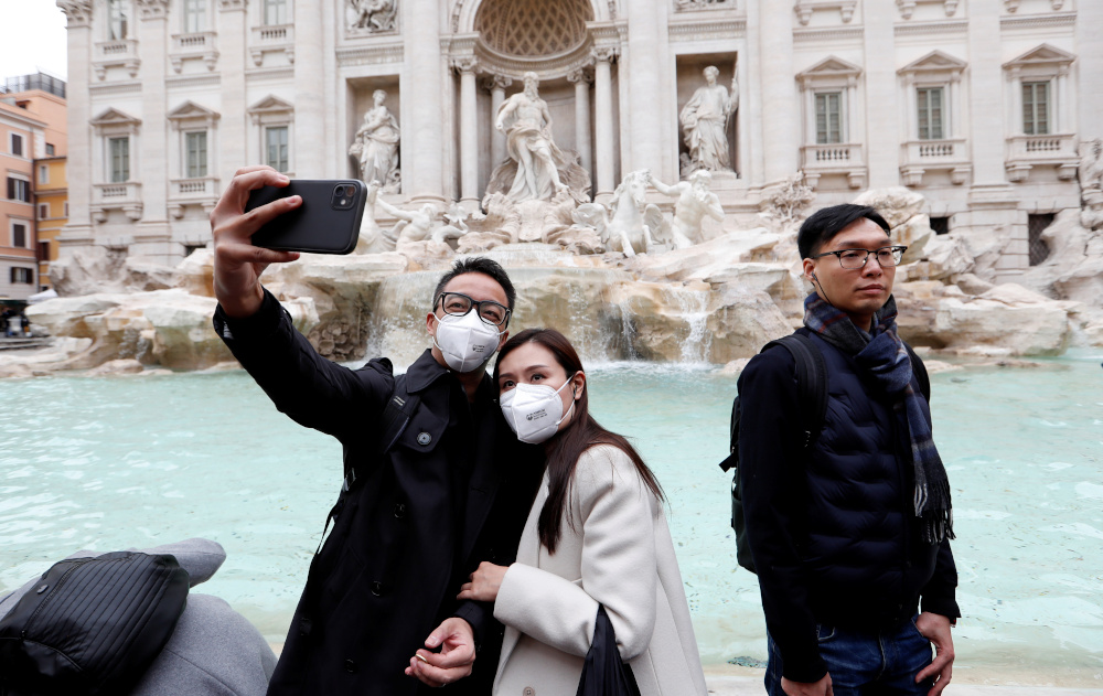 Tourists wearing protective masks take a selfie in front of the Trevi Fountain after two cases of coronavirus were confirmed in in the country, in Rome, Italy January 31, 2020. u00e2u20acu201d Reuters pic 