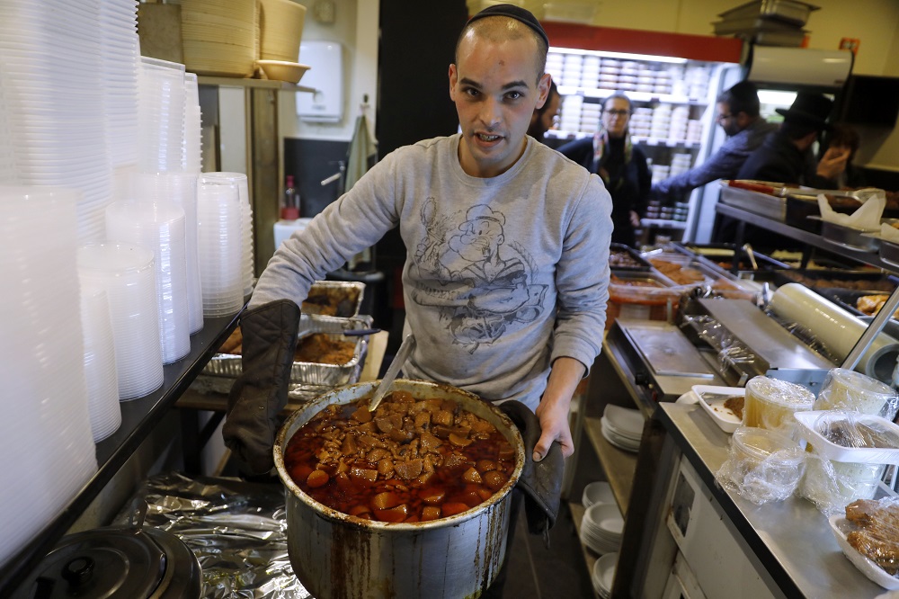A religious Jewish cook holds a pot of Hamin, the traditional Jewish long cooking stew, at the Maadaniyat Shef restaurant in the ultra-Orthodox city of Bnei Brak, Israel January 16, 2020. u00e2u20acu201d AFP pic