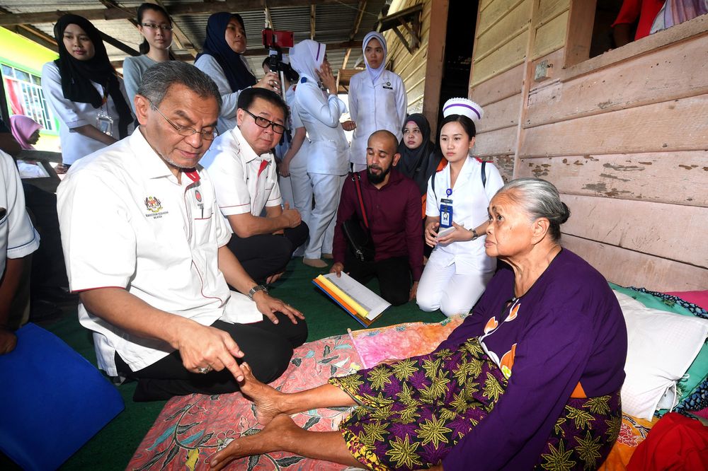 Health Minister Datuk Seri Dr Dzulkefly Ahmad (left) talking to Jain Isnani, 63, who suffered from sore foot and high blood pressure during the launch of the u00e2u20acu02dcJelajah Kampungku Sihau00e2u20acu2122 programme in Kampung Kabogan, Semporna, Sabah, February 22, 2020. u00e2u20ac
