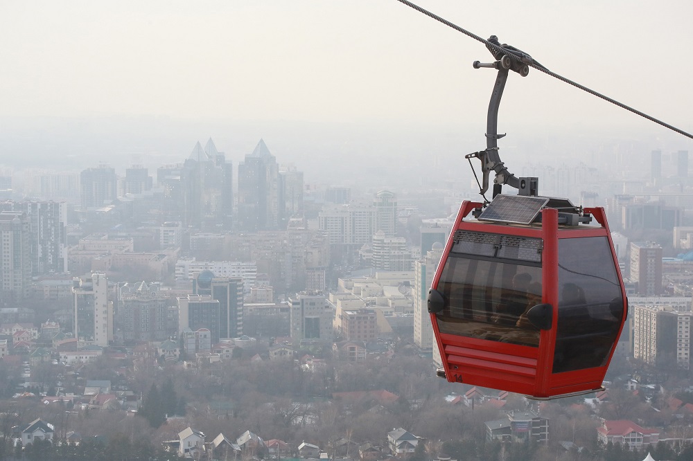 People ride a cable car as smog covers Almaty, Kyrgyzstan February 10, 2020. — AFP pic