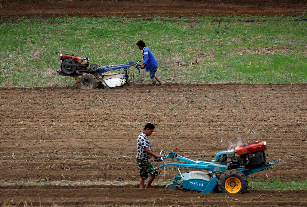 Farmers use tractors to plough the field as they wait for the monsoon rains to harvest rice in Lalitpur, Nepal June 26, 2019. — Reuters pic