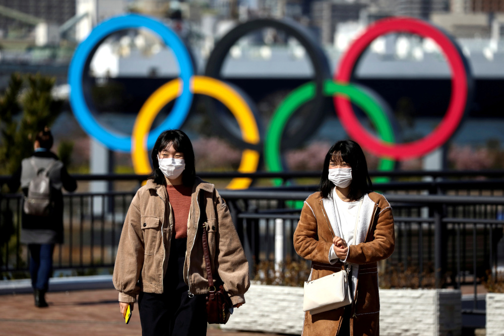 People wearing protective face masks, following an outbreak of the coronavirus, are seen in front of the Giant Olympic rings at the waterfront area at Odaiba Marine Park in Tokyo, Japan, February 27, 2020. u00e2u20acu201d Reuters pic 