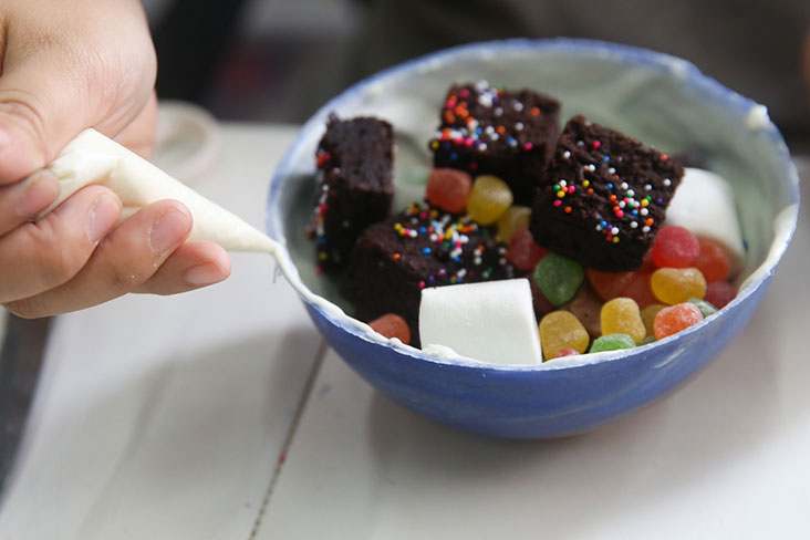 One side of the chocolate shell will be filled with goodies such as pieces of cake, candy and chocolates