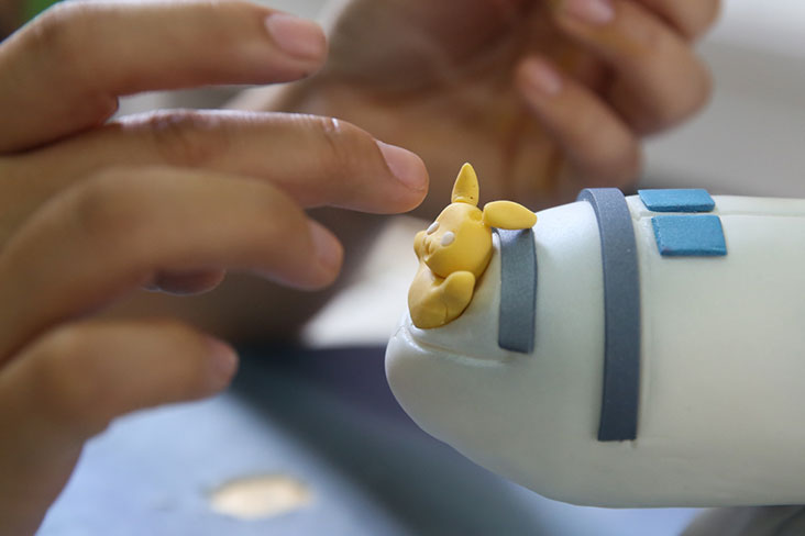 As the birthday boy is a fan of Pokemon, a fondant pikachu was added to the space shuttle